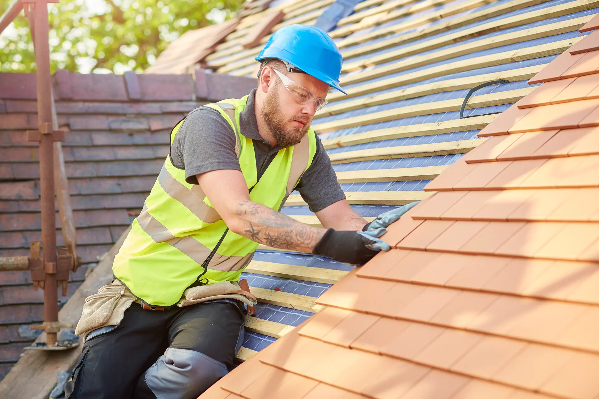 Roofer nailing roof tiles on a Christchurch property for Apex Roofing Services Ltd