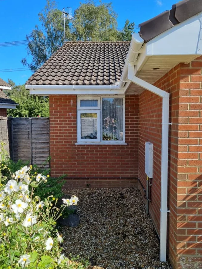 New guttering installed along a residential roofline in East Dorset by Apex Roofing Services