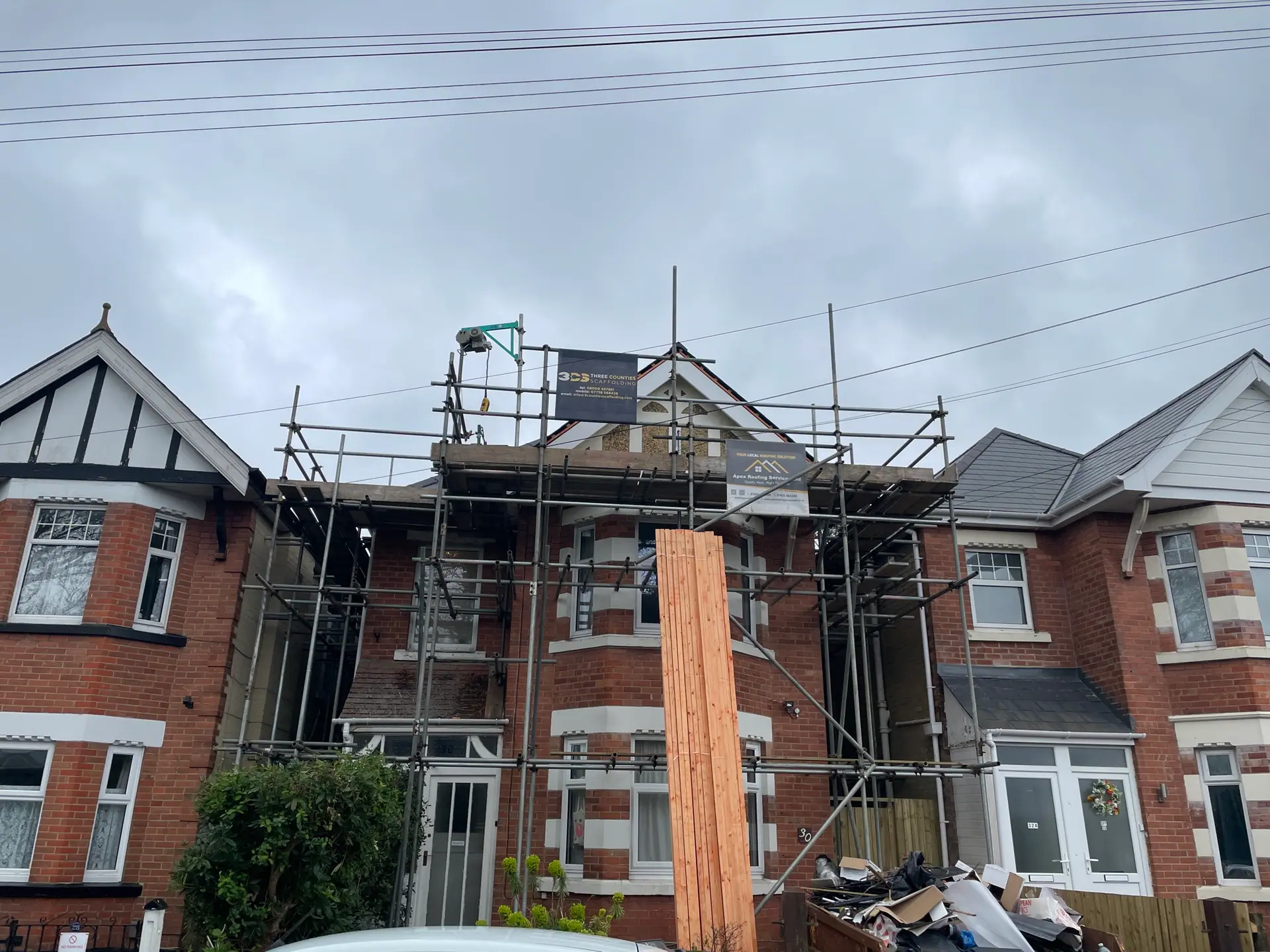 House roof repair with scaffolding set up around the building, Apex Roofing Services Bournemouth
