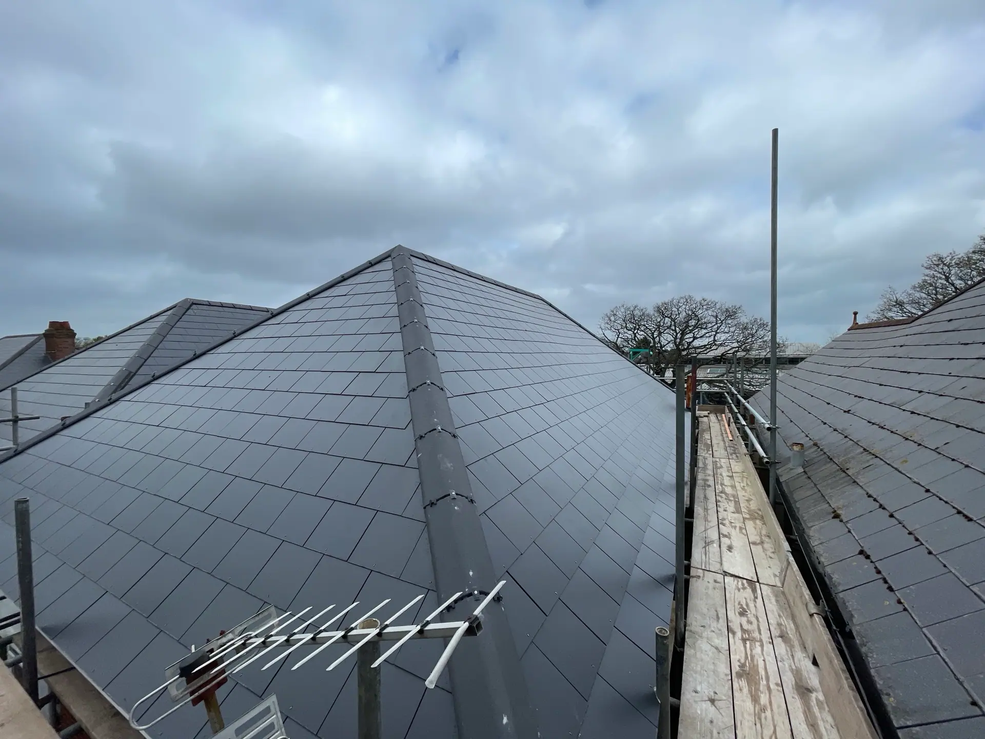 Black tiled residential roof with a clean finish, Apex Roofing Services Bournemouth