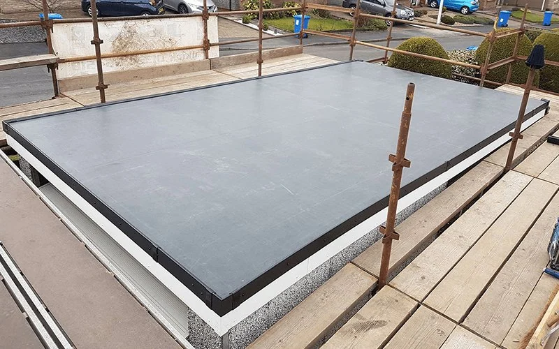 Flat roof surface prepared for EPDM installation surrounded by scaffolding, Apex Roofing Services Bournemouth