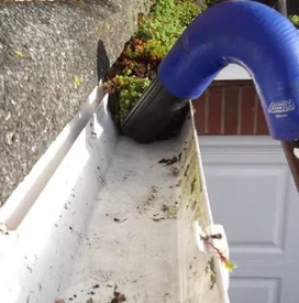 Guttering system being emptied and cleaned by Apex Roofing Services Bournemouth