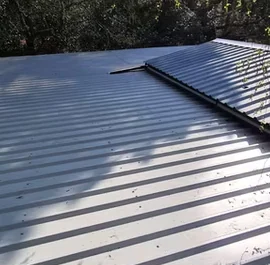 Silver sheet metal roofing reflecting the sun, Apex Roofing Services Bournemouth