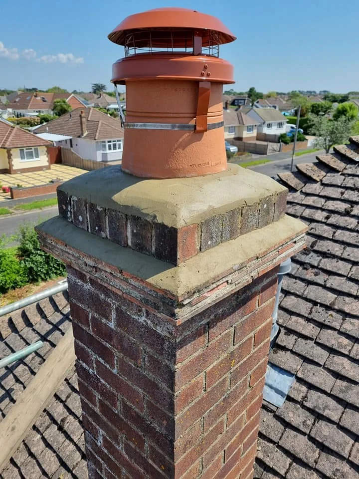 Residential roof with chimney and ridge tile detail completed by Apex Roofing Services Bournemouth